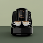 Black coffee machine with two white cups filled with coffee on a white background